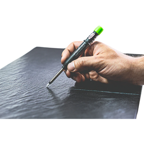 Hand using Pica-Dry Longlife Automatic Pen to mark wet glossy surface – precision graphite on dusty/rough jobsites.